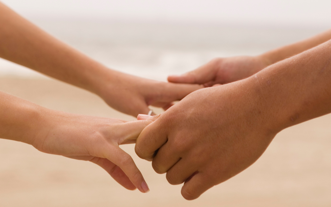 a couple healing by holding hands after Betrayal Trauma