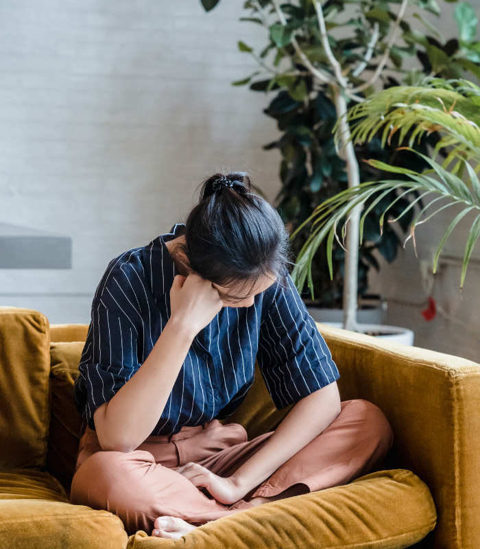 person sad on couch 
