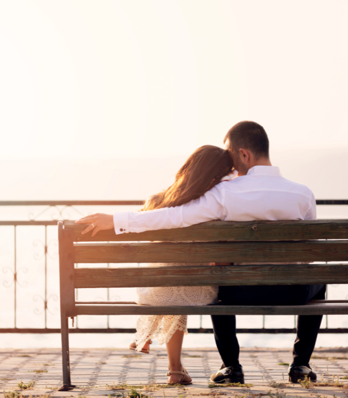married couple sitting an a bench together